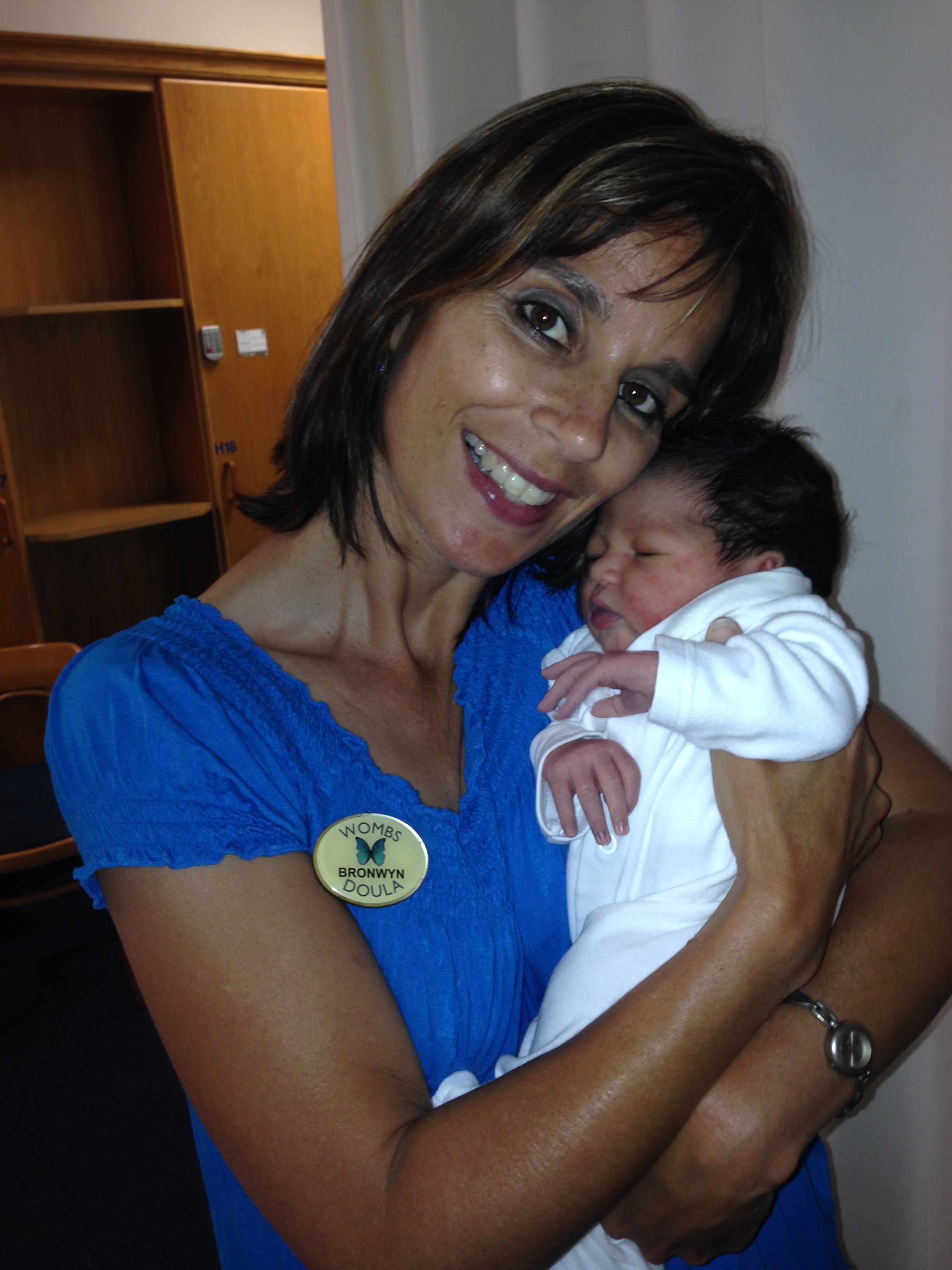 A WOMBS doula cradling a newborn baby