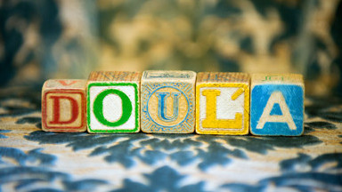 Wooden alphabet blocks spelling the word DOULA