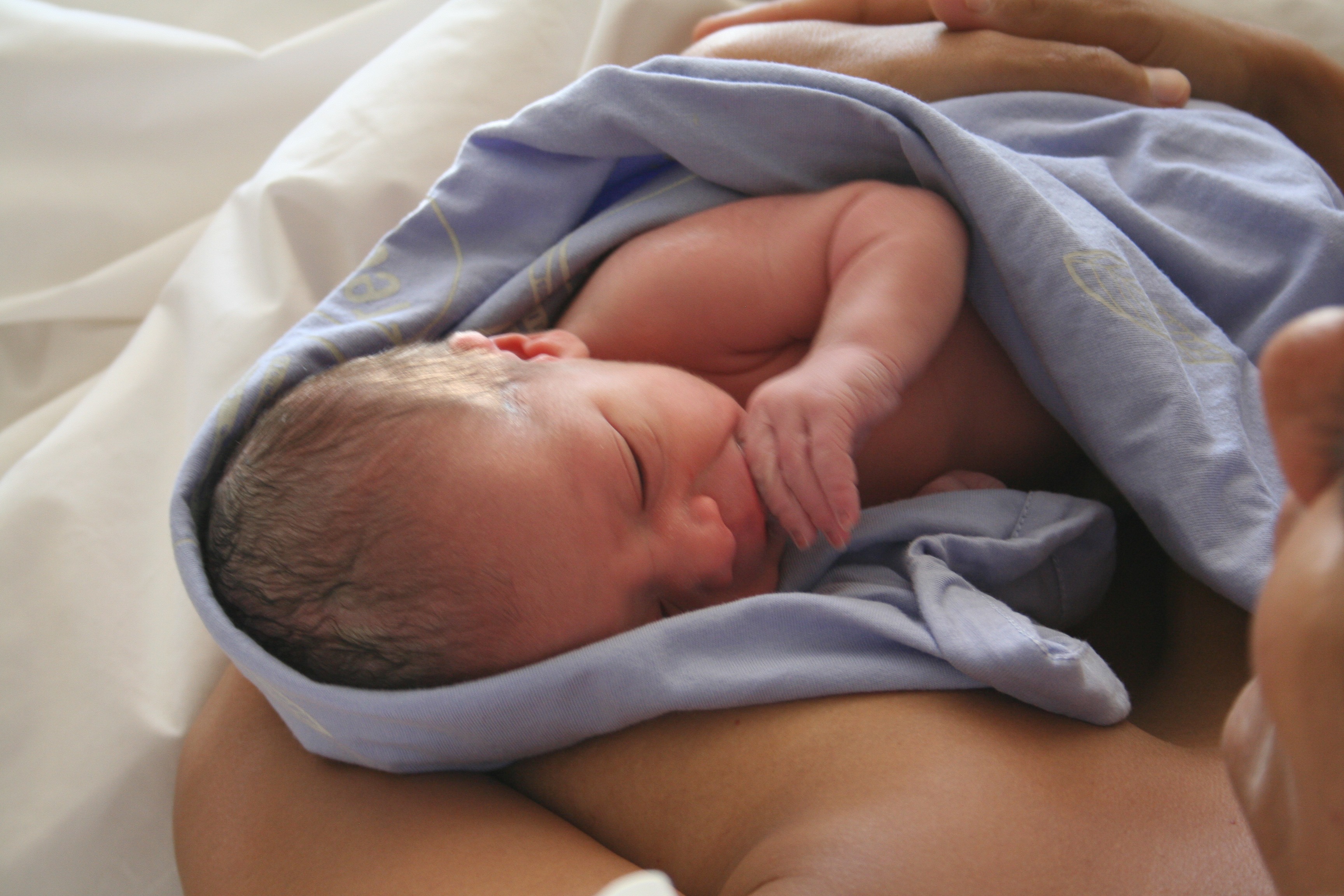 Newborn baby resting on mother's chest