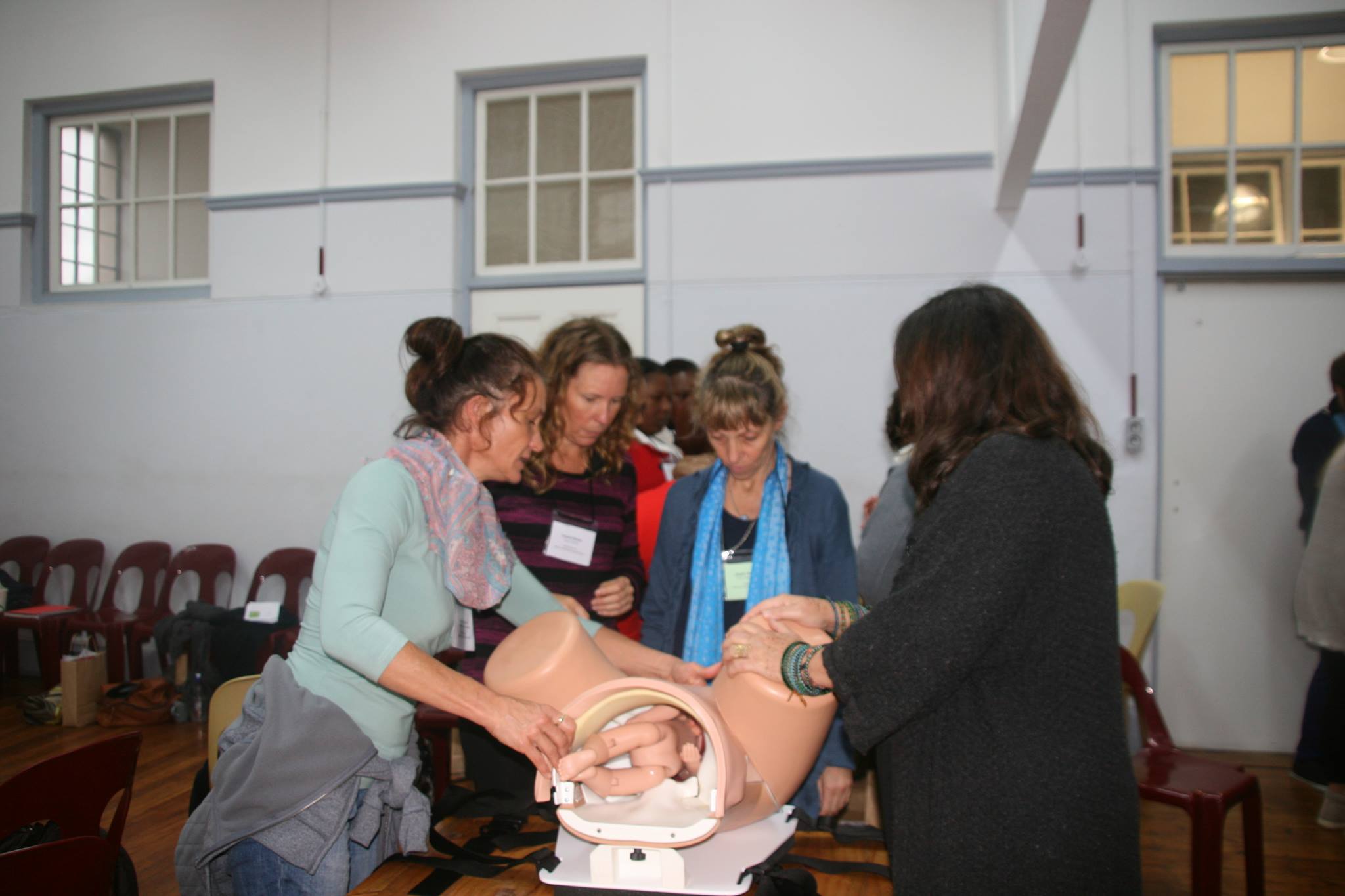 Trainees practising with a birth simulation model