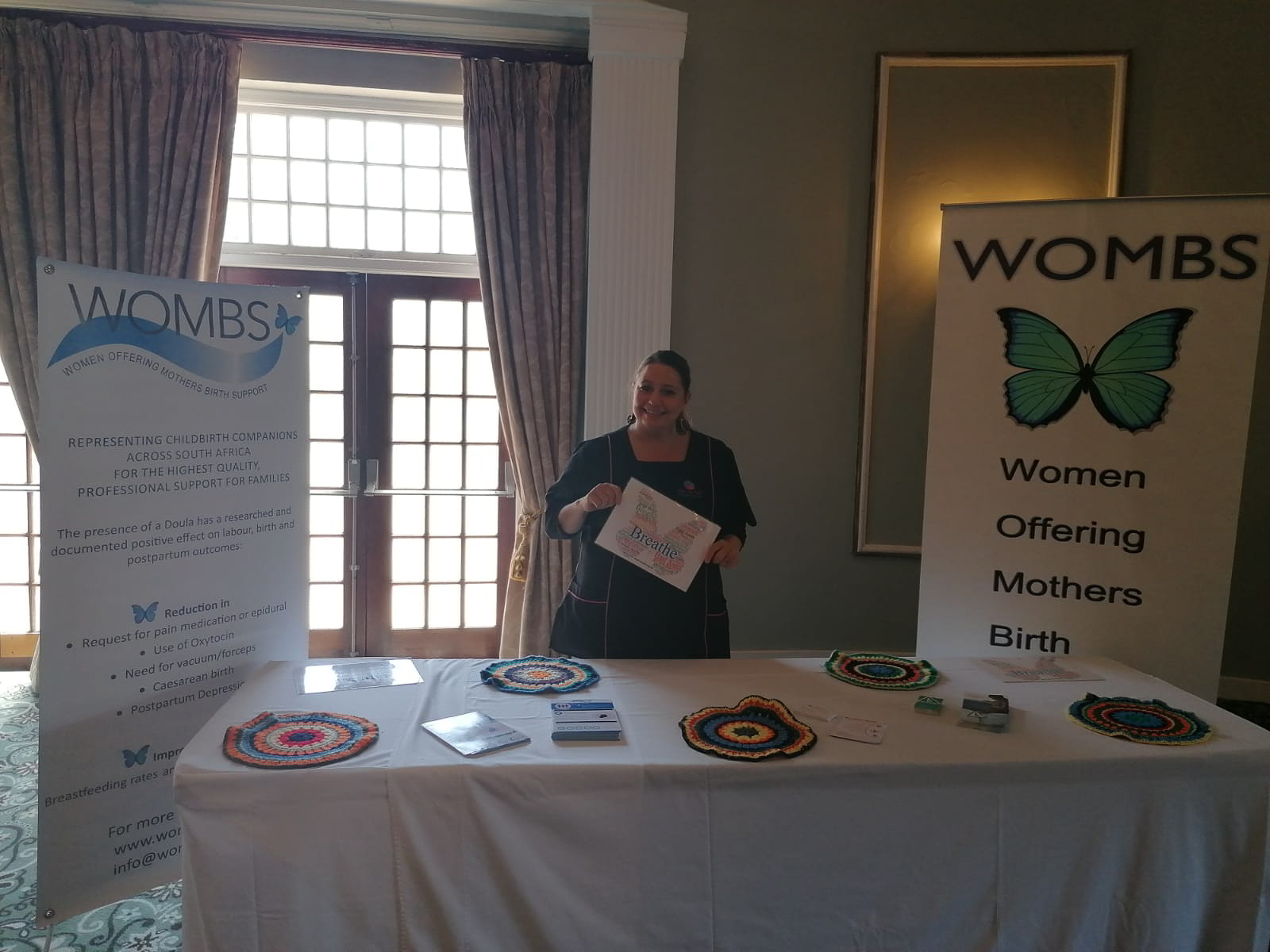 WOMBS doula presenting the Breathe poster at an event
